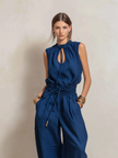 Dark blue FJØRNA women's cotton-linen jumpsuit with round neck, sleeveless design, slim fit, and pants style.