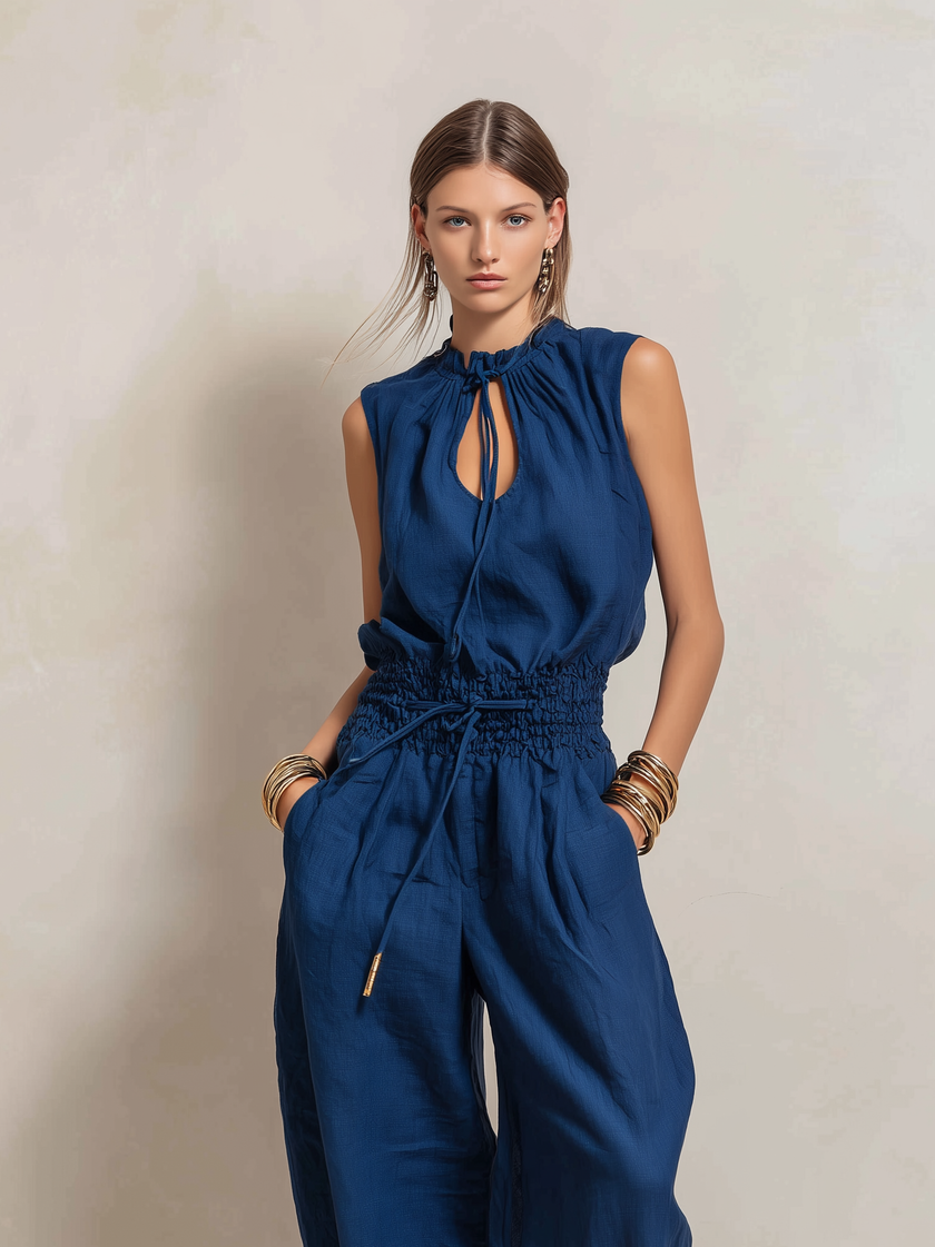 Dark blue FJØRNA women's cotton-linen jumpsuit with round neck, sleeveless design, slim fit, and pants style.