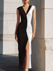 FJØRNA black and white ruched evening gown with high slit, elegant contrast dress featuring a fitted silhouette and sophisticated design.