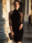 FJØRNA sheer-sleeve high-neck cocktail dress for women, elegant black dress with sheer long sleeves and high neckline.
