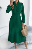 FJØRNA solid color long-sleeved fitted waist pleated elegant midi dress displayed on a model, showcasing its sophisticated design.