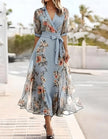 Blue midi dress for women by FJØRNA with lapel collar and printed design, shown on a hanger.