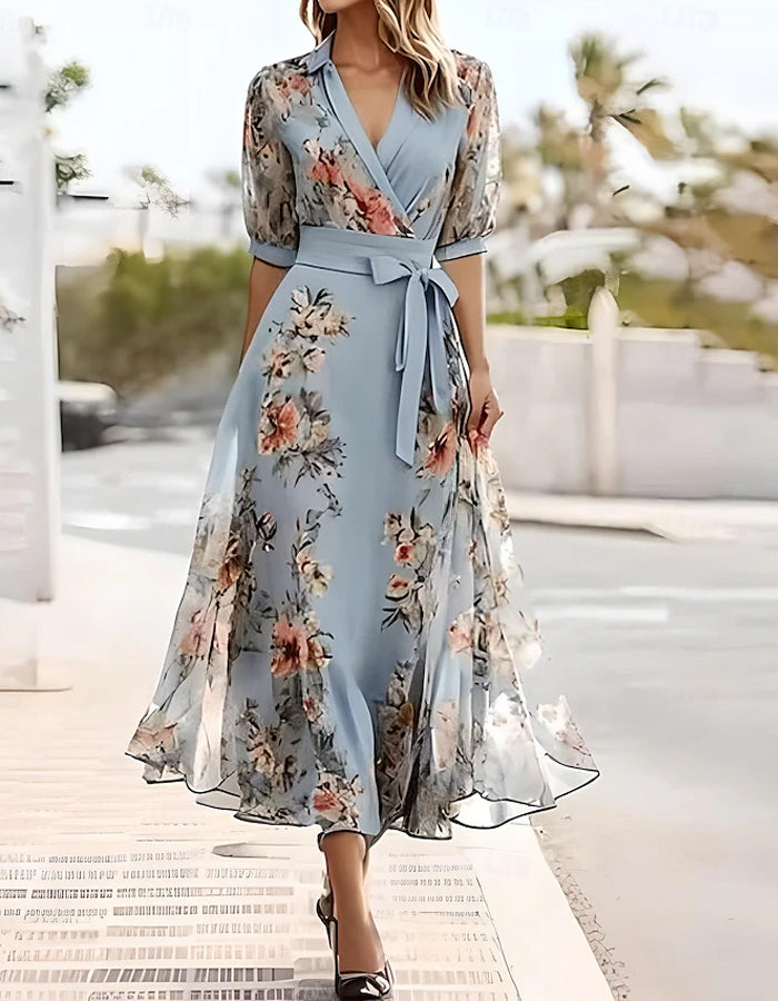 Blue midi dress for women by FJØRNA with lapel collar and printed design, shown on a hanger.