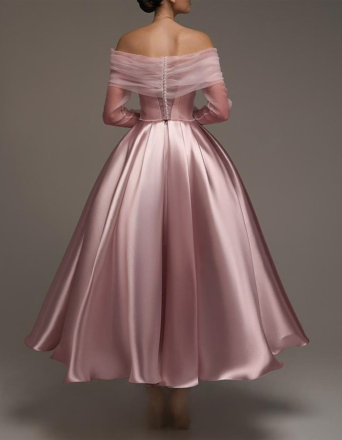 Pink satin midi dress for women by FJØRNA, strapless A-line design with shawl and strappy details, shown on a model.