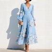 FJØRNA floral print long-sleeved V-neck pleated dress with elegant floral design and flowing silhouette.