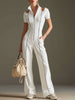 White cotton blend short sleeve wide-leg jumpsuit by FJØRNA, showing its relaxed fit and stylish design.