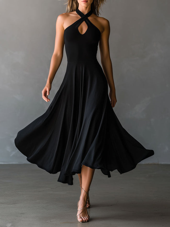 Black FJØRNA halter neck midi dress, elegant evening dress with fitted bodice and flowing skirt, showcased on model.