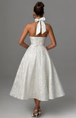 FJØRNA Bruna wedding guest halter midi dress in navy, elegant sleeveless design for wedding or special occasions.