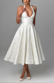 FJØRNA Bruna wedding guest halter midi dress in navy, elegant sleeveless dress with a fitted waist and flowing skirt.