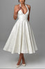 FJØRNA Bruna wedding guest halter midi dress in navy, elegant sleeveless dress with a fitted waist and flowing skirt.