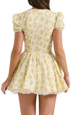 Yellow Emily floral V-neck corset mini dress from FJØRNA, featuring a fitted bodice and lightweight fabric.