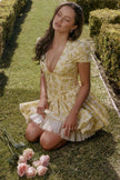 Yellow Emily floral V-neck corset mini dress by FJØRNA, featuring a fitted waist and romantic floral pattern.