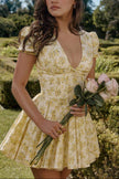 Yellow Emily Floral V-neck Corset Mini Dress by FJØRNA with a fitted bodice and floral print, styled for a chic summer look.