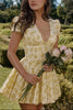 Yellow Emily Floral V-neck Corset Mini Dress by FJØRNA with a fitted bodice and floral print, styled for a chic summer look.