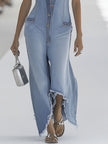 Light blue denim sleeveless jumpsuit with raw edges and wide-leg design by FJØRNA, displayed on a hanger.