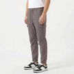 Men's slim fit cotton cargo trousers by FJØRNA, showing the beige trousers with side pockets and relaxed fit.