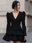 FJØRNA black leather mini dress with dramatic puff sleeves and tiered design, showcasing the stylish, fitted silhouette.