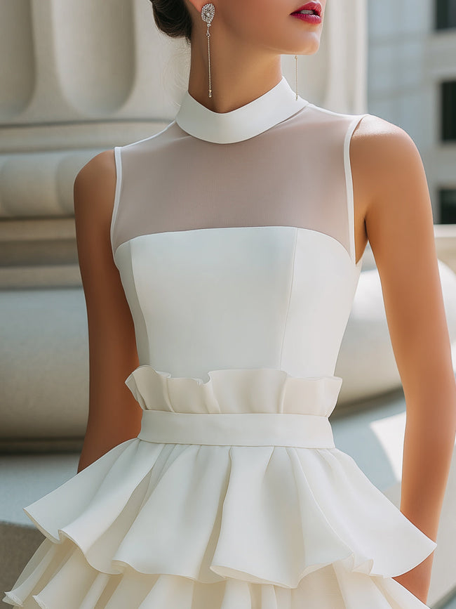 FJØRNA high-neck sheer yoke tiered ruffle mini dress showcasing a delicate, layered design with a high neckline and sheer yoke detail.