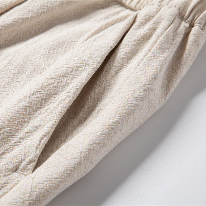 Men’s lightweight linen blend trousers by FJØRNA, casual summer pants with relaxed fit and breathable fabric, shown in a neutral color.