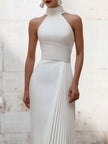 FJØRNA elegant satin pleated halter-neck evening gown, shown in rich fabric with flowing pleats and a stylish halter neckline.