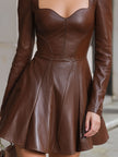 FJØRNA brown leather sweetheart neckline mini dress with a glamorous edge, featuring fitted style and elegant design.