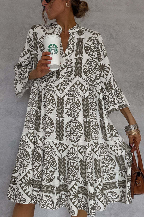 FJØRNA floral printed V-neck bell sleeve mini dress showcasing a colorful floral pattern and bell sleeve design.