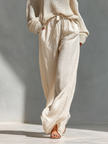 Women’s beige linen-blend high-waisted wide-leg trousers with pockets by FJØRNA, featuring a relaxed fit and elegant style.