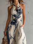 White ink wash print sleeveless halter neck wide-leg jumpsuit by FJØRNA with pockets, stylish and comfortable for casual wear.