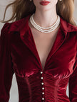 Red velvet pleated ruffled long sleeve blouse by FJØRNA, showcasing elegant pleats and ruffle details on a stylish blouse.