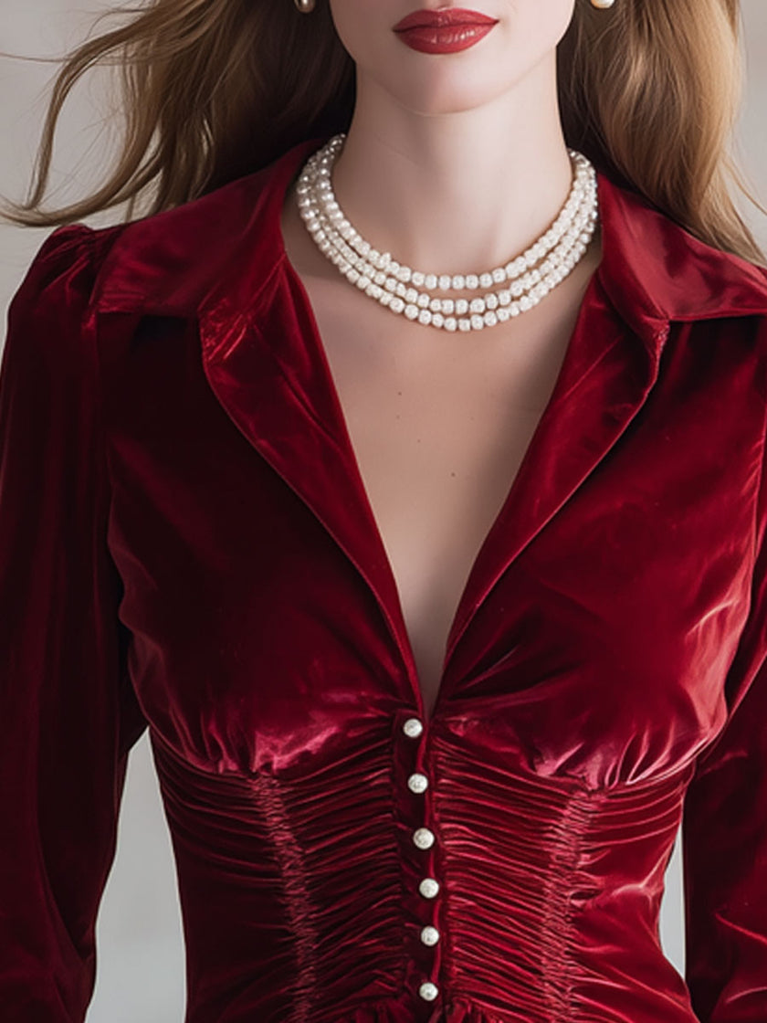 Red velvet pleated ruffled long sleeve blouse by FJØRNA, showcasing elegant pleats and ruffle details on a stylish blouse.
