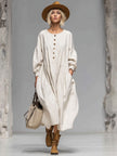 FJØRNA cotton button-front midi dress for women, featuring a classic design with a fitted waist and midi length, displayed on a model.