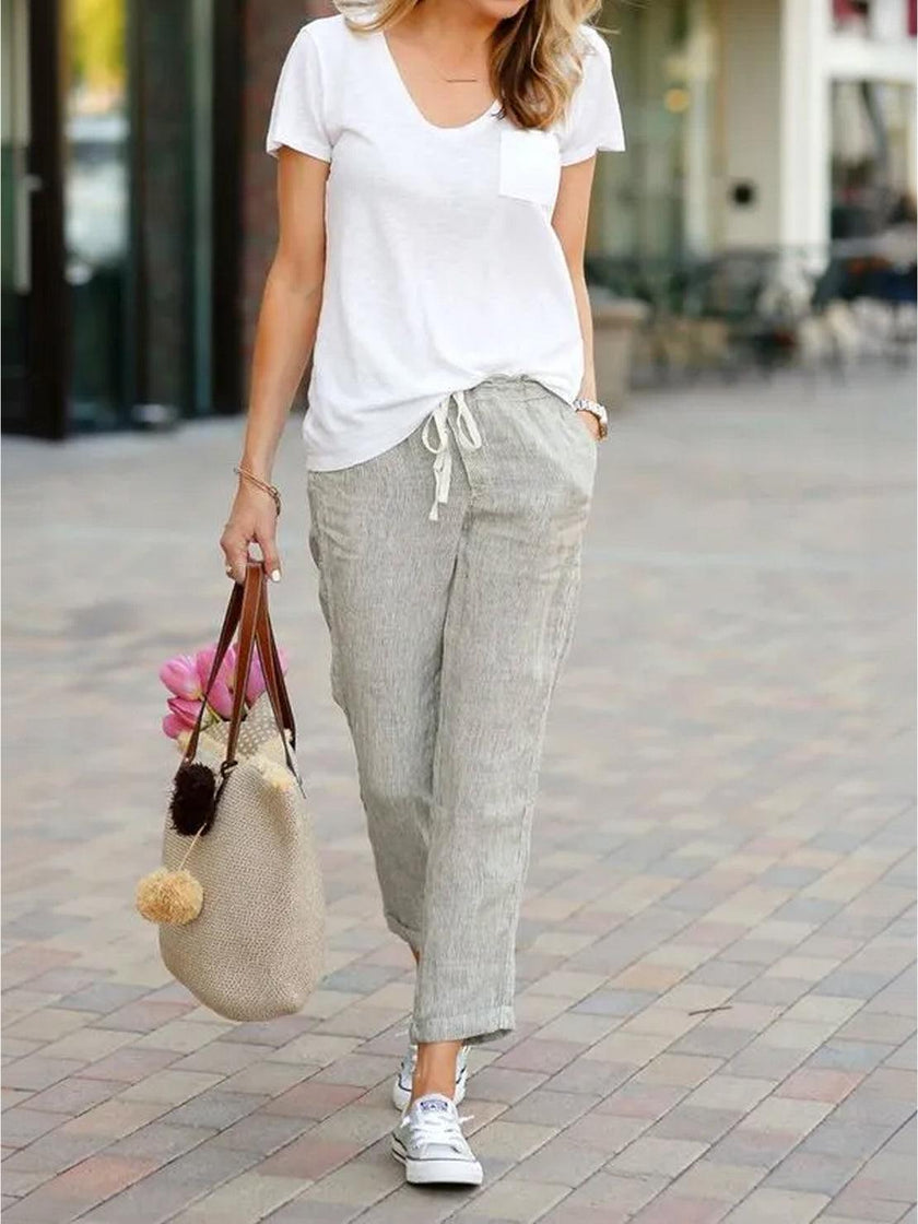 FJØRNA Felicity women's drawstring casual pants in neutral fabric, featuring a relaxed fit and adjustable waist for comfortable wear.