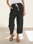 FJØRNA Felicity women's drawstring casual pants in neutral fabric, featuring a relaxed fit and adjustable waistband.