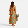 Women's floral maxi dress by FJØRNA featuring a relaxed boho style with vibrant floral patterns and flowing fabric.