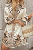 FJØRNA champagne mini dress with printed V-neck, lantern sleeves, and waist tie, perfect for stylish occasions.