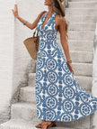 FJØRNA white halter print backless maxi dress displayed on a hanger, featuring a flowing design and open back for a stylish look.
