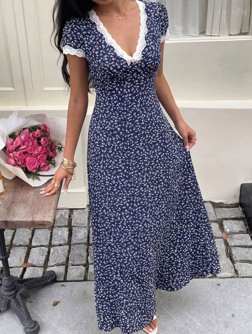 White lace patch floral V-neck maxi dress by FJØRNA with intricate lace details and flowing fabric, perfect for elegant occasions.