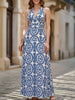 White FJØRNA halter print backless maxi dress featuring a flowing design and open back, perfect for summer occasions.