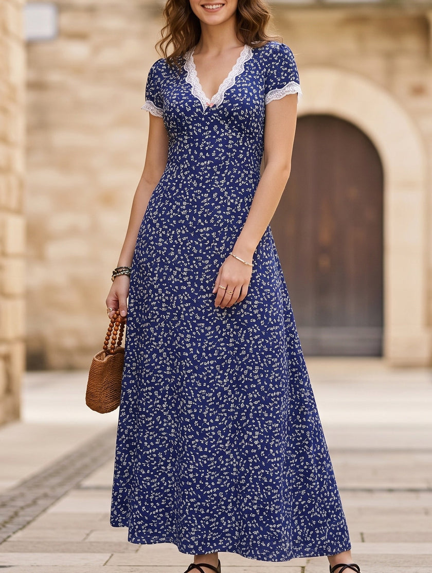 White FJØRNA lace patch floral V-neck maxi dress with intricate lace details and flowing fabric, perfect for elegant occasions.