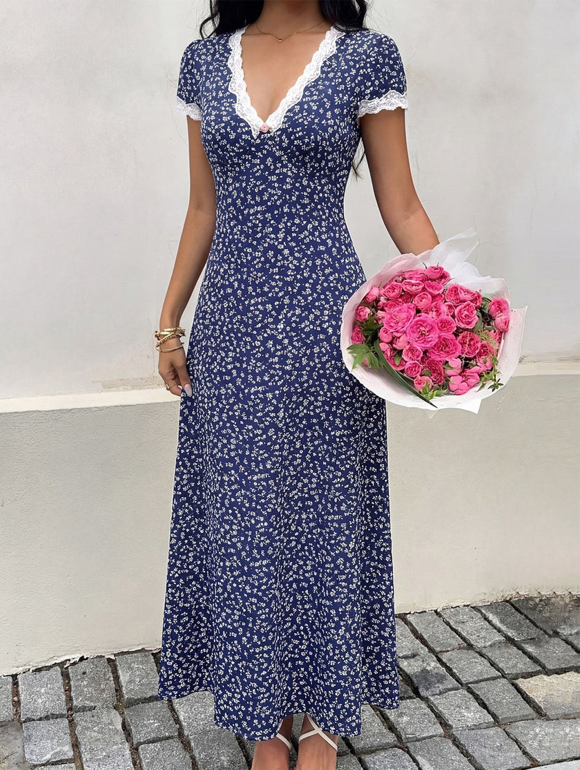FJØRNA lace patch floral V-neck maxi dress in white, featuring delicate lace details and flowing fabric.