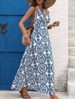 White FJØRNA halter print backless maxi dress featuring a flowy silhouette and elegant design, perfect for summer occasions.