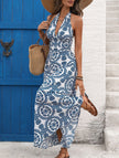 FJØRNA white halter print backless maxi dress with flowing fabric and elegant design, perfect for summer or special occasions.