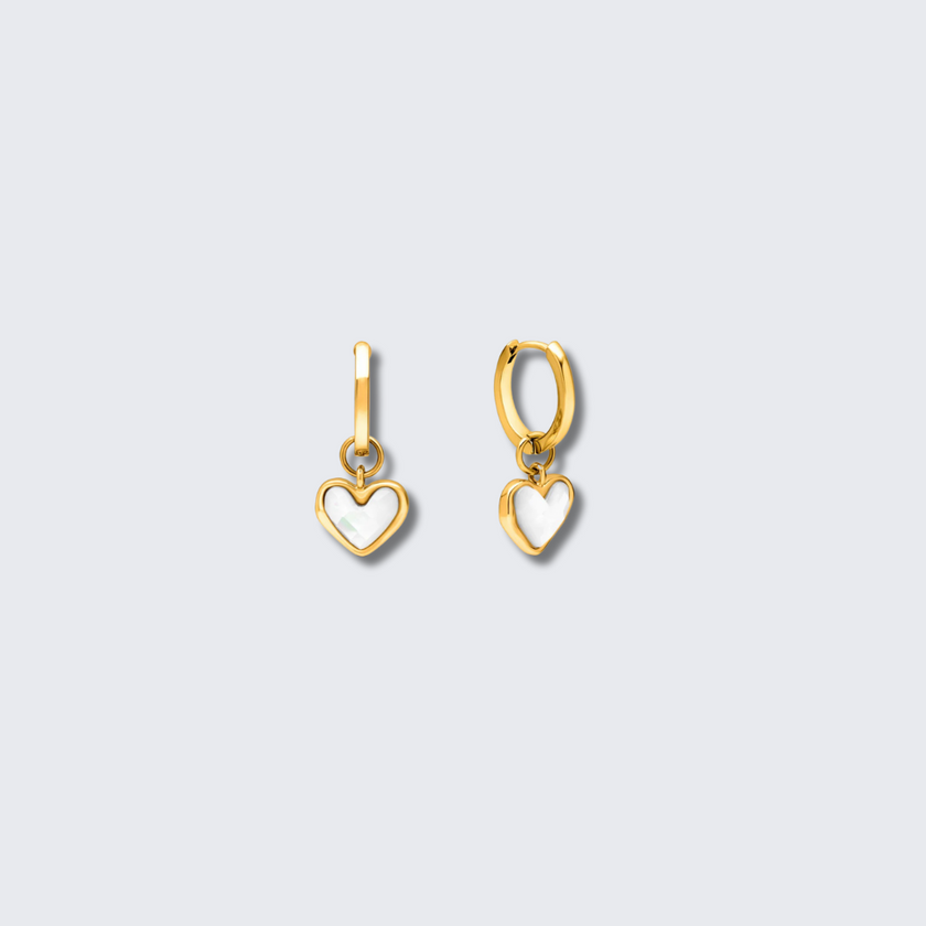 Gold FJØRNA White Quartz Heart Huggie Earrings for women, close-up of elegant heart-shaped white quartz earrings with gold setting.
