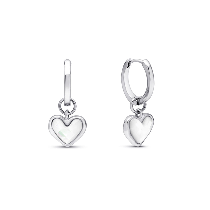 Silver FJØRNA White Quartz Heart Huggie Earrings for women, close-up of heart-shaped white quartz stones in silver huggie hoops.