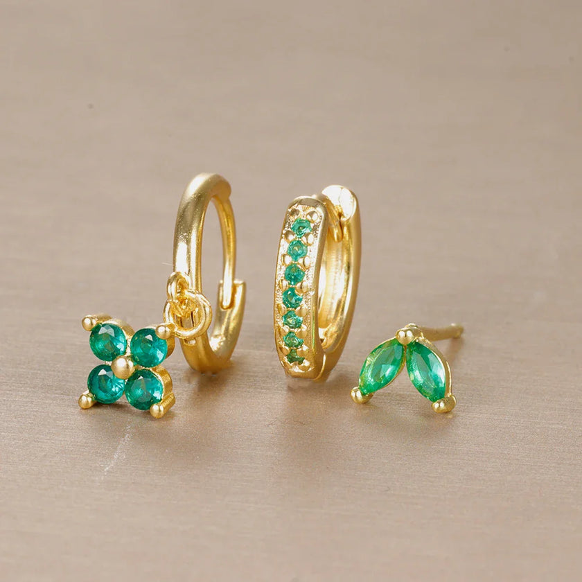 FJØRNA unisex piercing set with gold and green accessories for women, featuring stylish earrings and body jewelry for all-day wear.