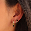 FJØRNA unisex piercing set with gold and green accessories, featuring stylish, comfortable jewelry for women.