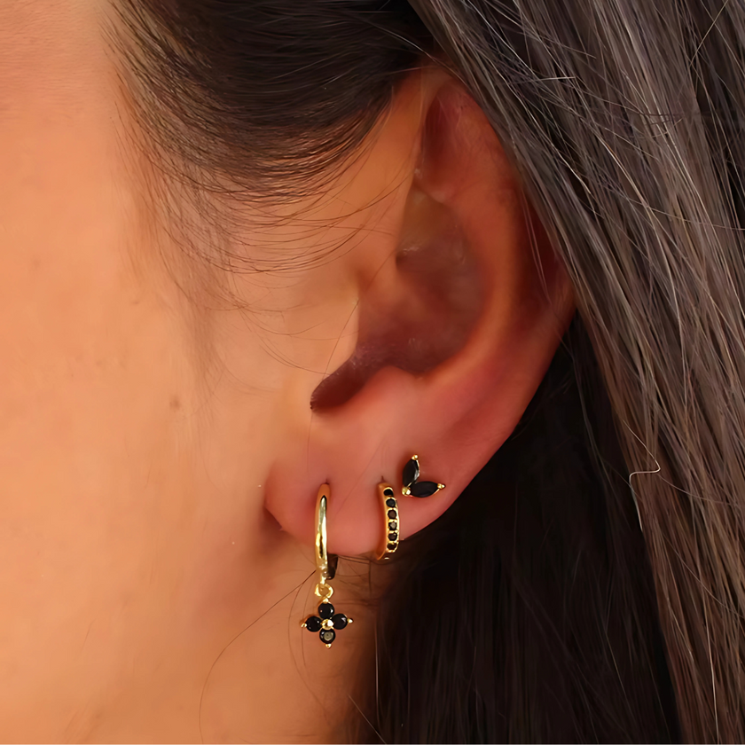 FJØRNA unisex piercing set with gold and green accessories, featuring stylish, comfortable jewelry for women.