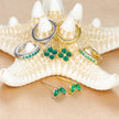 FJØRNA unisex piercing set with gold and green accessories, featuring stylish hoops and studs for effortless, all-day comfort.