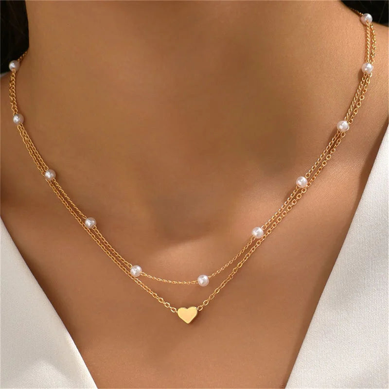 FJØRNA Lily 3-layer gold and silver necklace set for women with heart or cross pendants, stylish accessories for women.