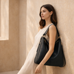 FJØRNA black vegan leather hobo shoulder bag with spacious interior and matching pouch, stylish and eco-friendly for women.